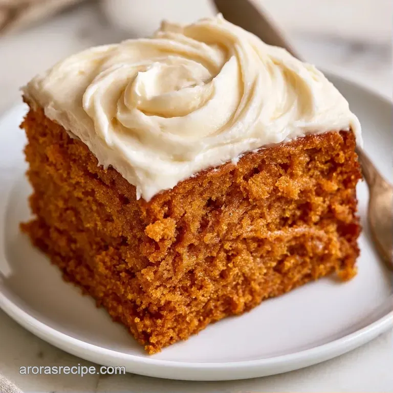 A slice of warm brown cake with creamy white frosting on a ceramic plate, garnished with a fresh cinnamon stick.